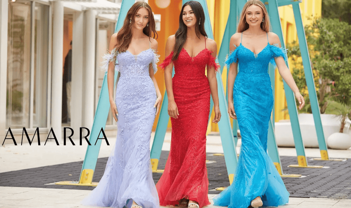 Three models walking outdoors in lace mermaid gowns with feathered off-shoulder straps, in lilac, red and blue