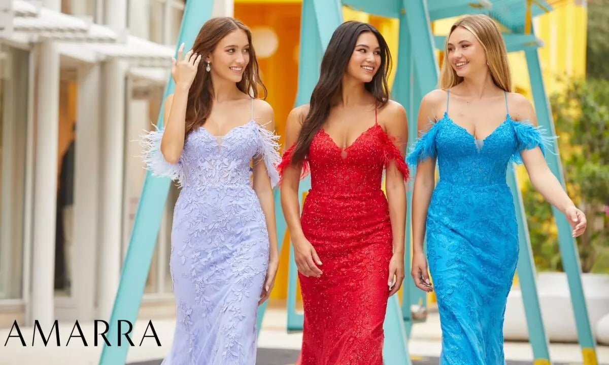 Three models walking in lilac, red and blue lace gowns with feather-trimmed off-shoulder straps