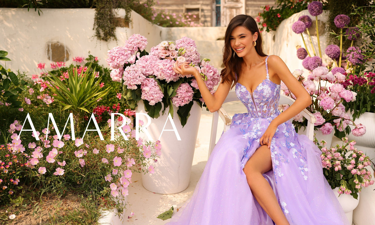 Amarra banner with a model in a lavender floral gown holding hydrangeas in a garden