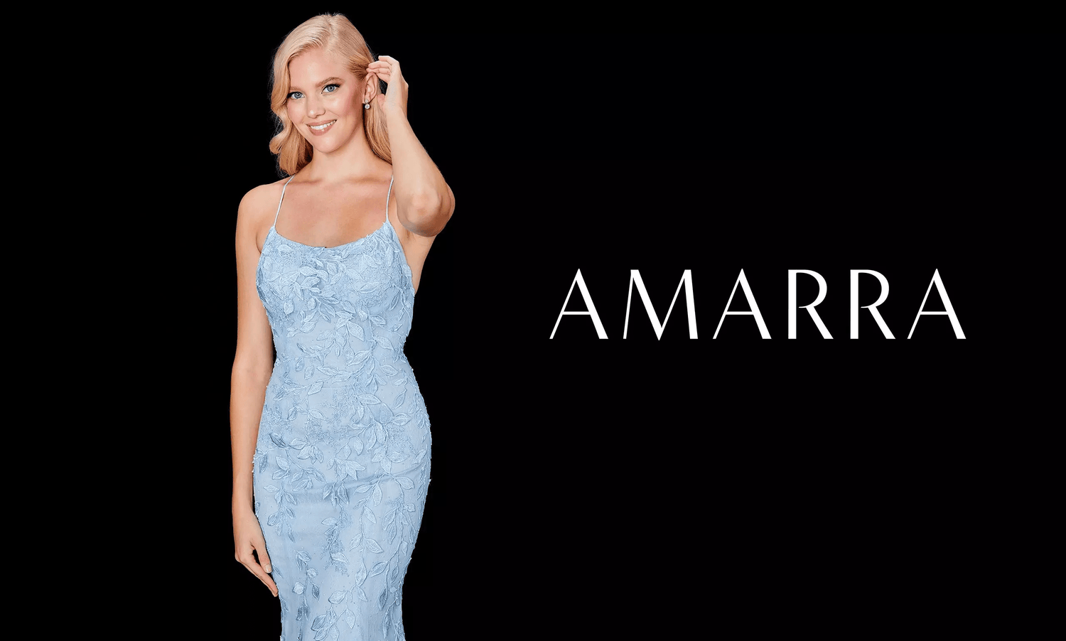 Blonde model with a hand in her hair wearing a light blue lace fitted gown