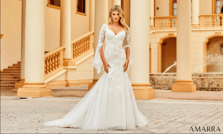 Bride in an ivory lace gown with sheer bell sleeves and tulle skirt on palazzo steps