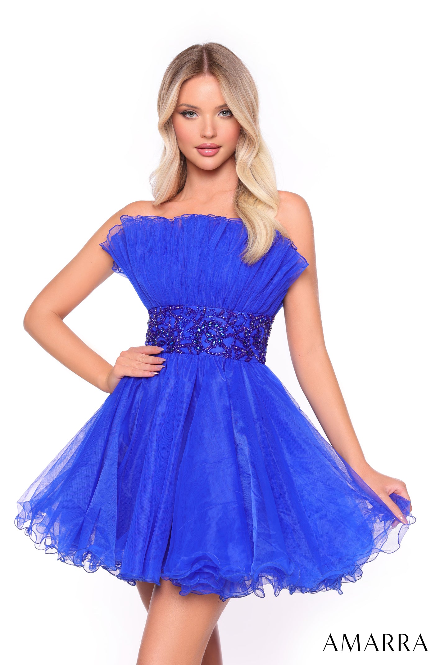 A blonde model wears a strapless, knee-length Bright Royal tulle dress with a beaded waistband.
