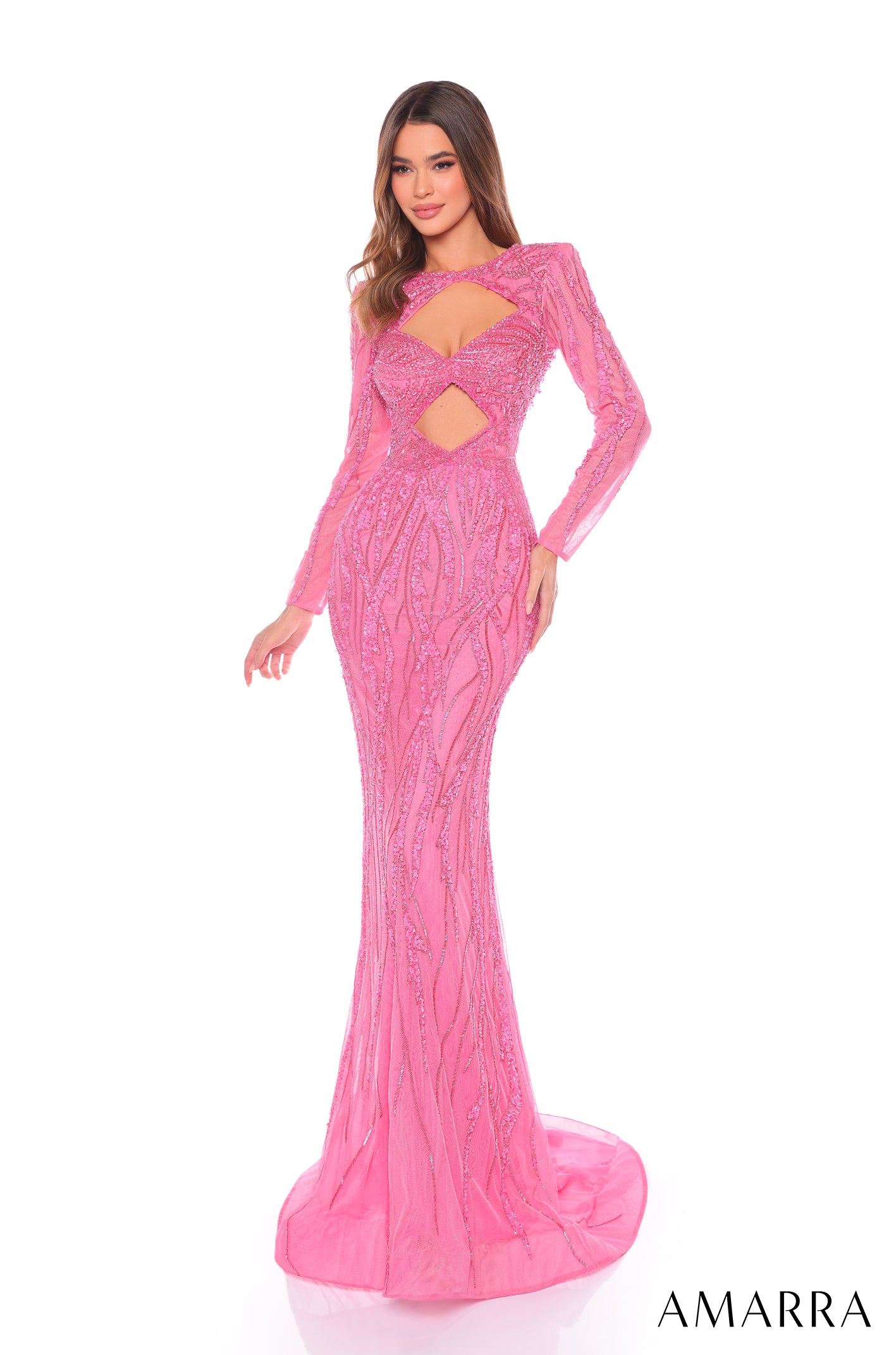 A long-sleeved, mermaid-style Bright Pink gown with cutouts and intricate sparkly beaded embellishments.