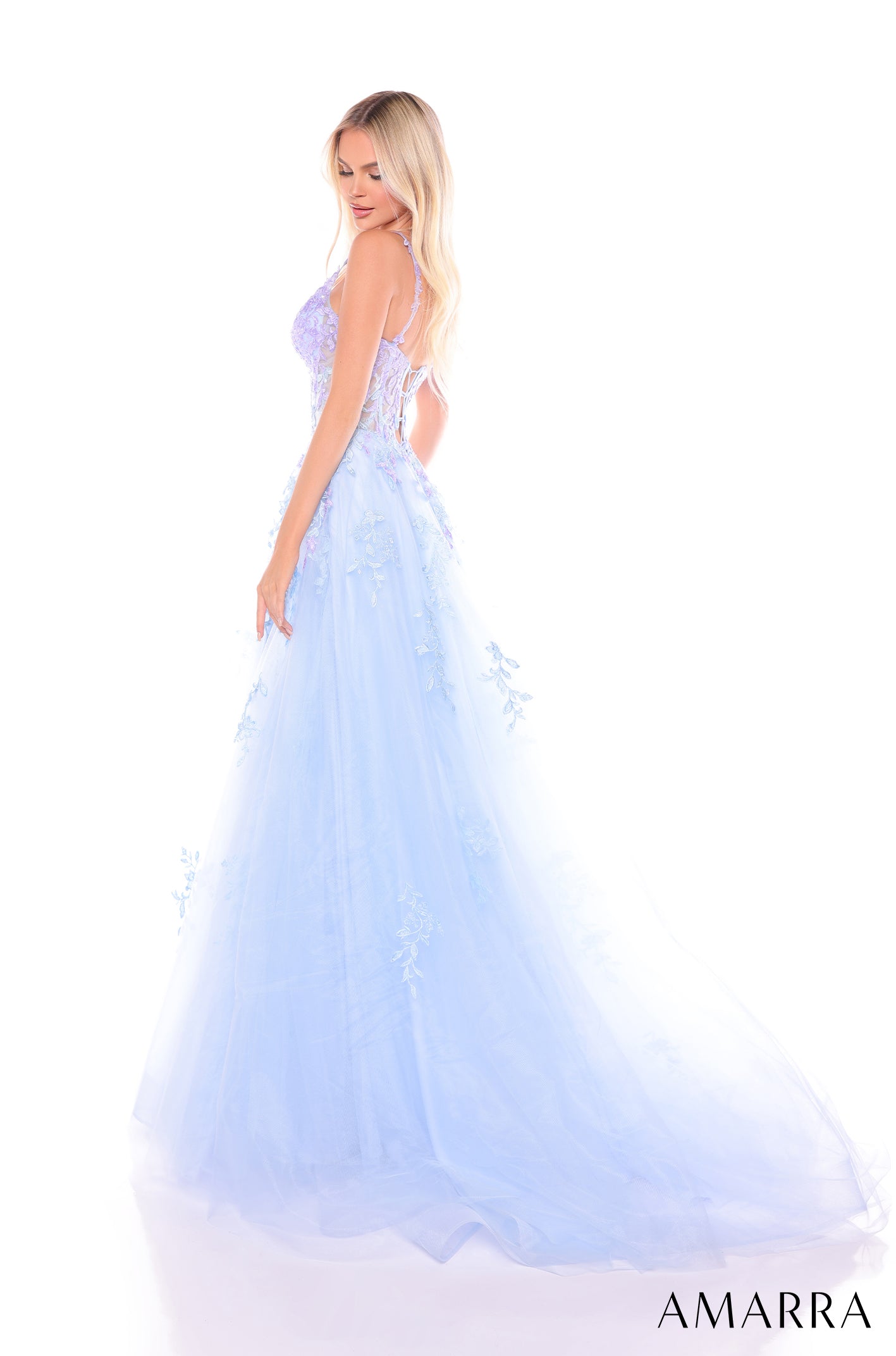 A pale blue, floor-length gown with floral appliqués and a flowing tulle skirt worn by a blonde model.
