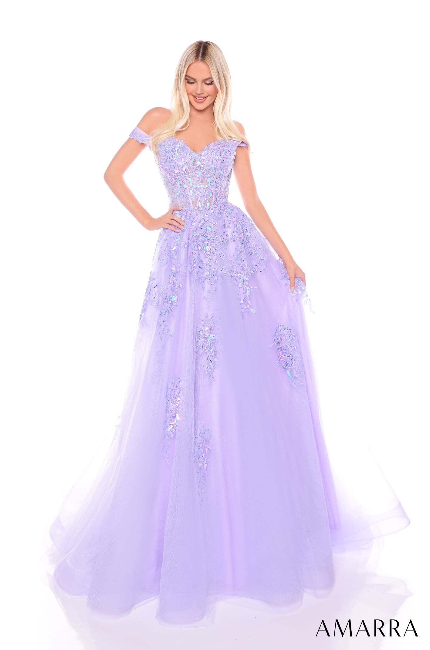 A woman wears a voluminous lilac off-shoulder ball gown with sparkling floral embellishments.