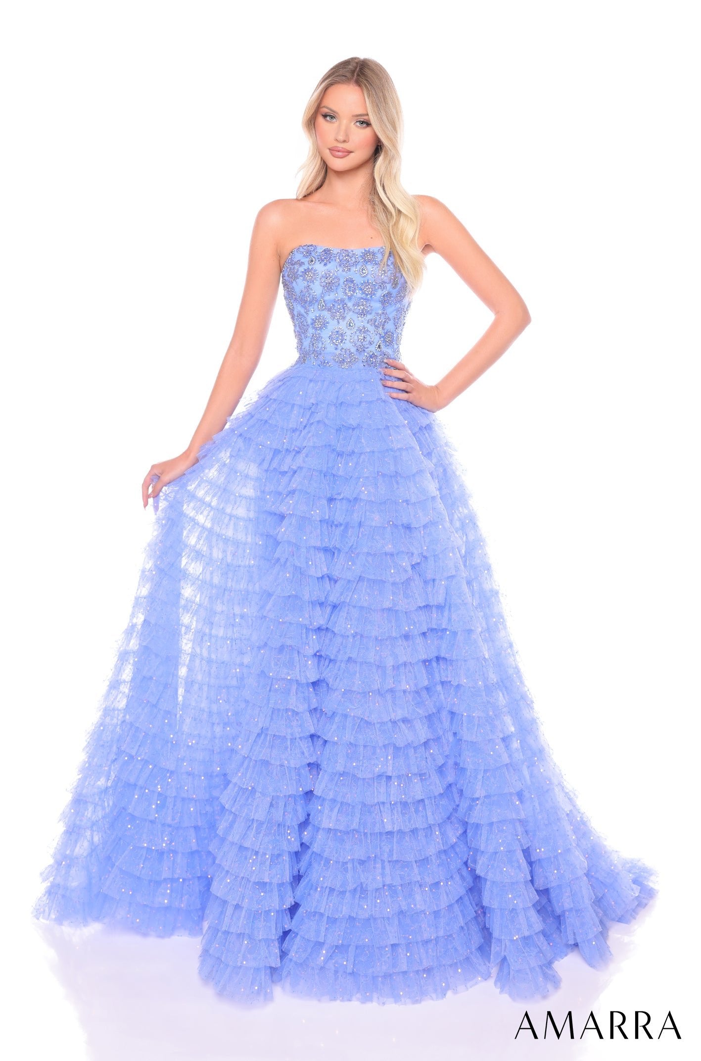 A strapless periwinkle ball gown with a fitted bodice and tiered, sparkly ruffled skirt.