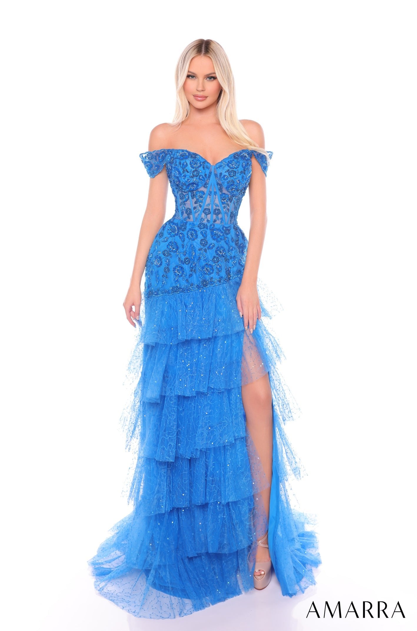 A long, tiered peacock blue off-shoulder gown with sparkling lace and a high side slit.
