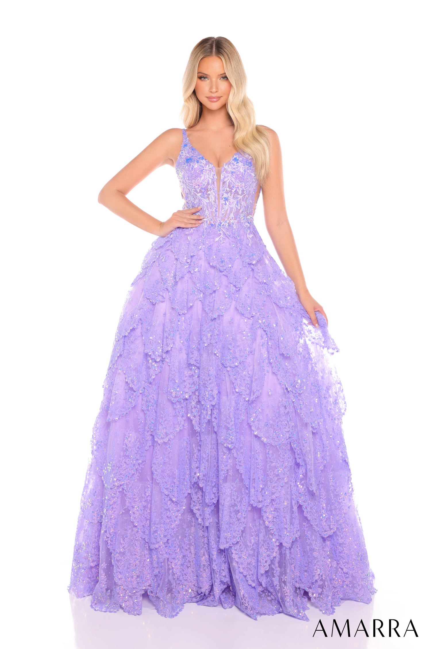 A model wears a lilac sequined ball gown with a plunging neckline and layered, sparkly skirt.