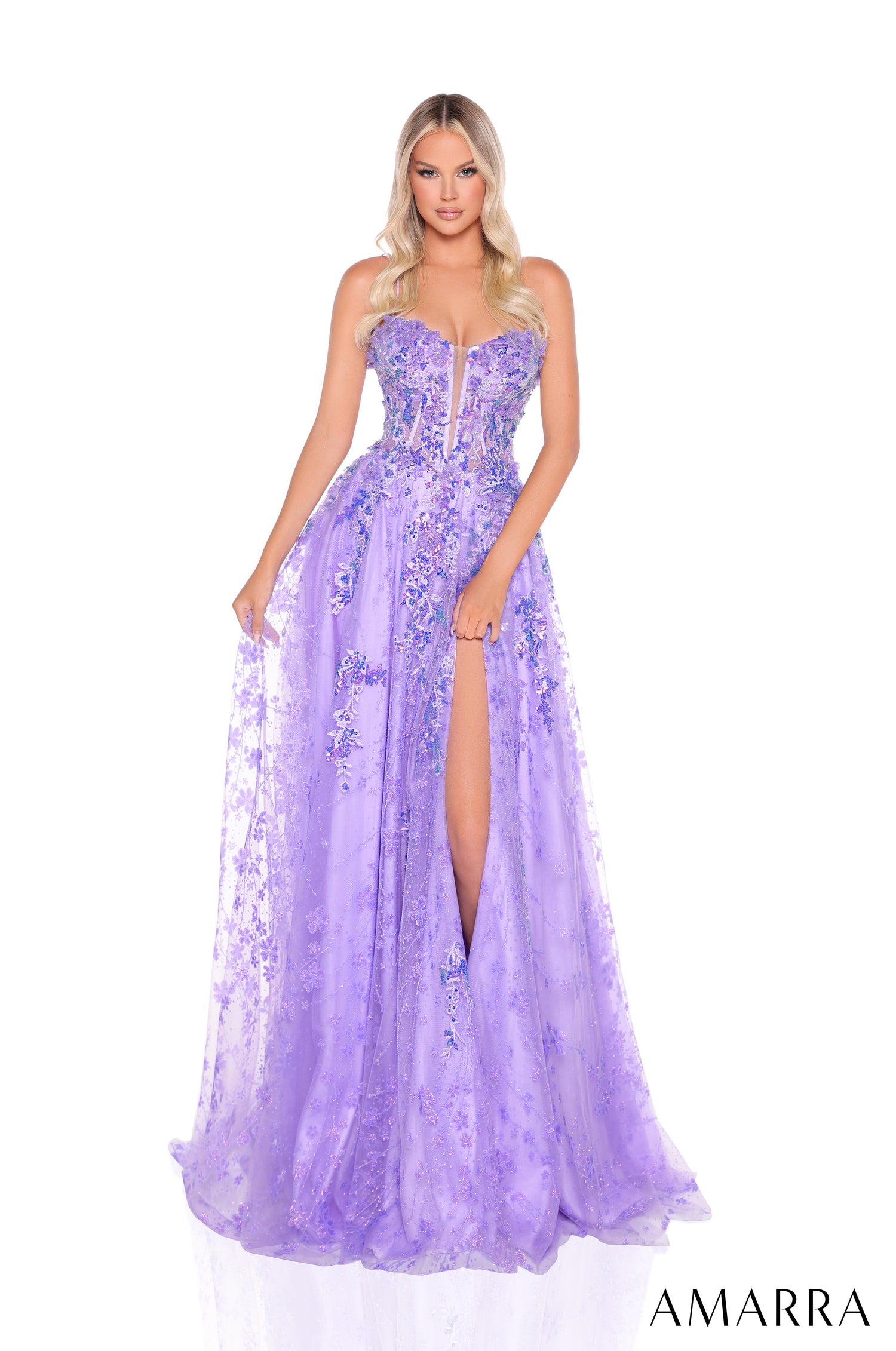 A model wears a lavender floral embellished corset ballgown with a high slit and flowing tulle skirt.