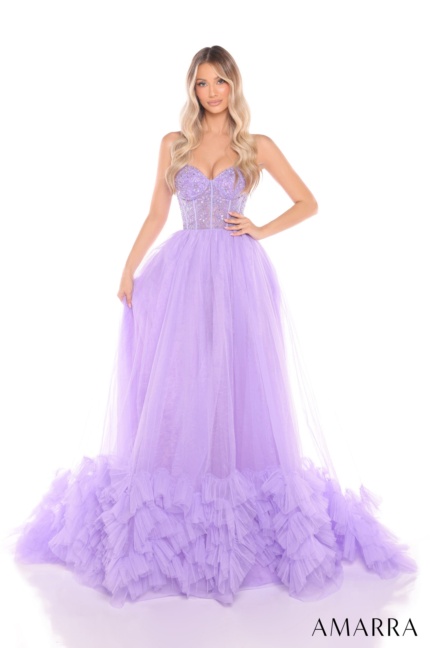 A woman wears a lilac tulle ballgown with a sequined corset bodice and dramatic ruffled hem.