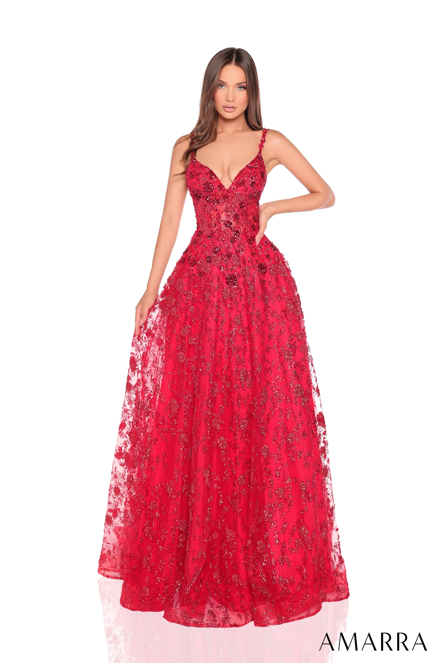 A floor-length red sequined ball gown with spaghetti straps, worn by a model against a white background.