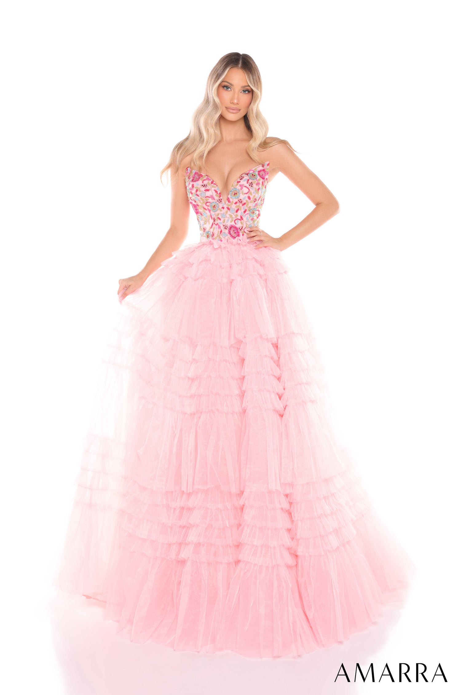 A woman wears a Light Pink/Multi tiered ball gown with a floral embellished bodice and voluminous tulle skirt.