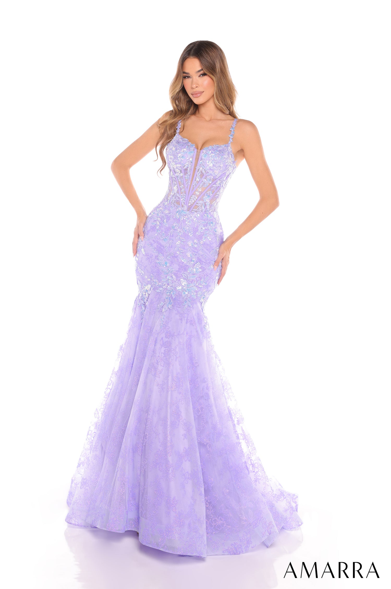A model wears a lilac mermaid-style sequined evening gown with a corseted bodice and flowing skirt.