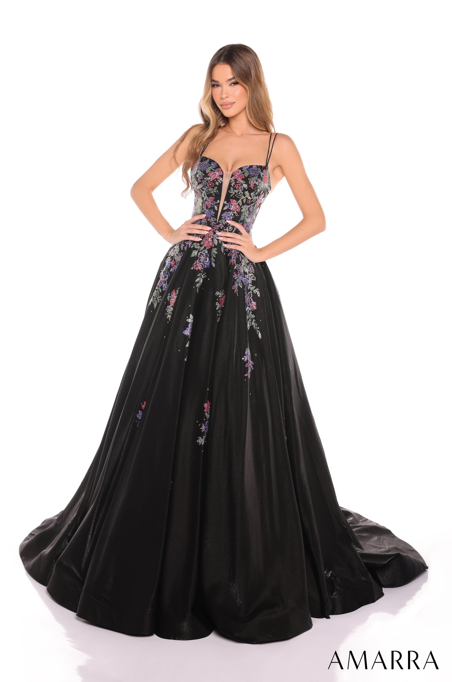 A model wears a Black floral embroidered ball gown with a sweetheart neckline and full skirt by Amarra.