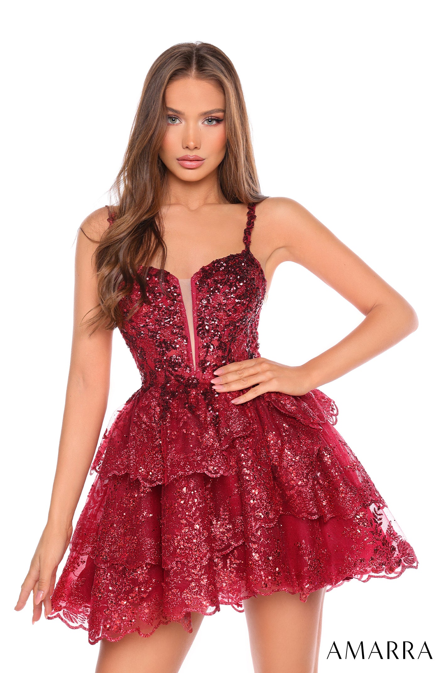 A woman wears a wine-colored sequined, tiered mini dress with sweetheart neckline from Amarra.