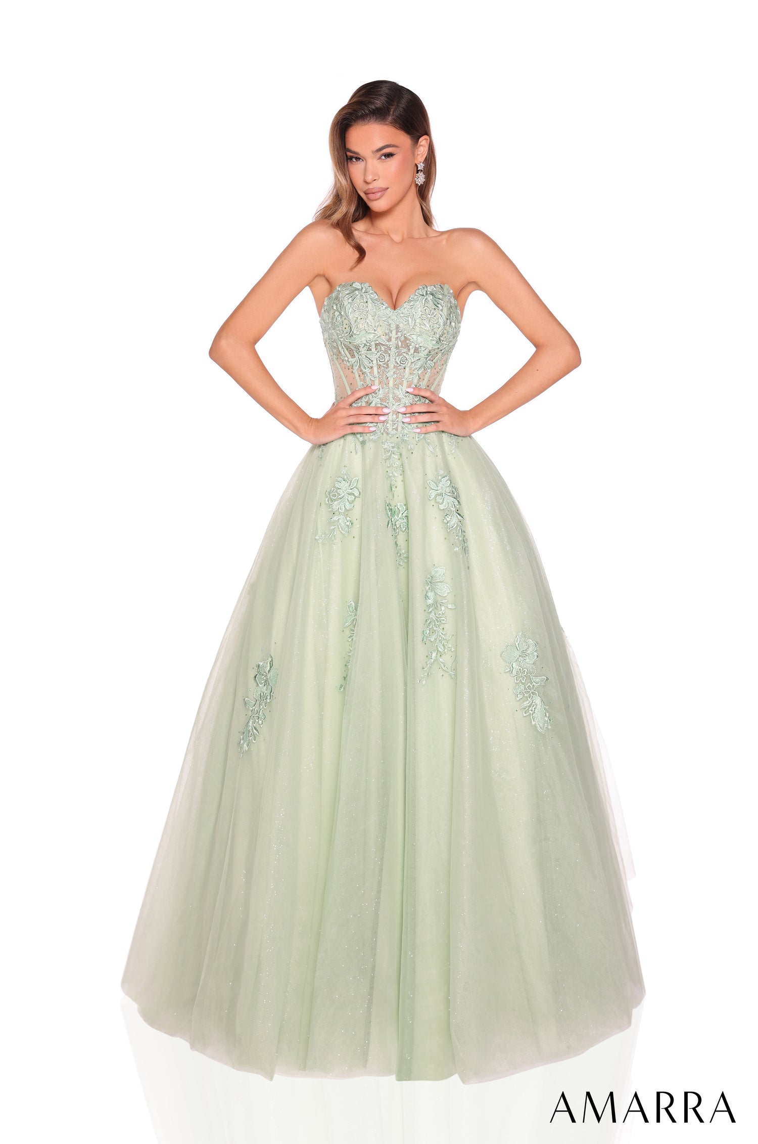 A strapless avocado green ball gown with a corset bodice and embellished tulle skirt.