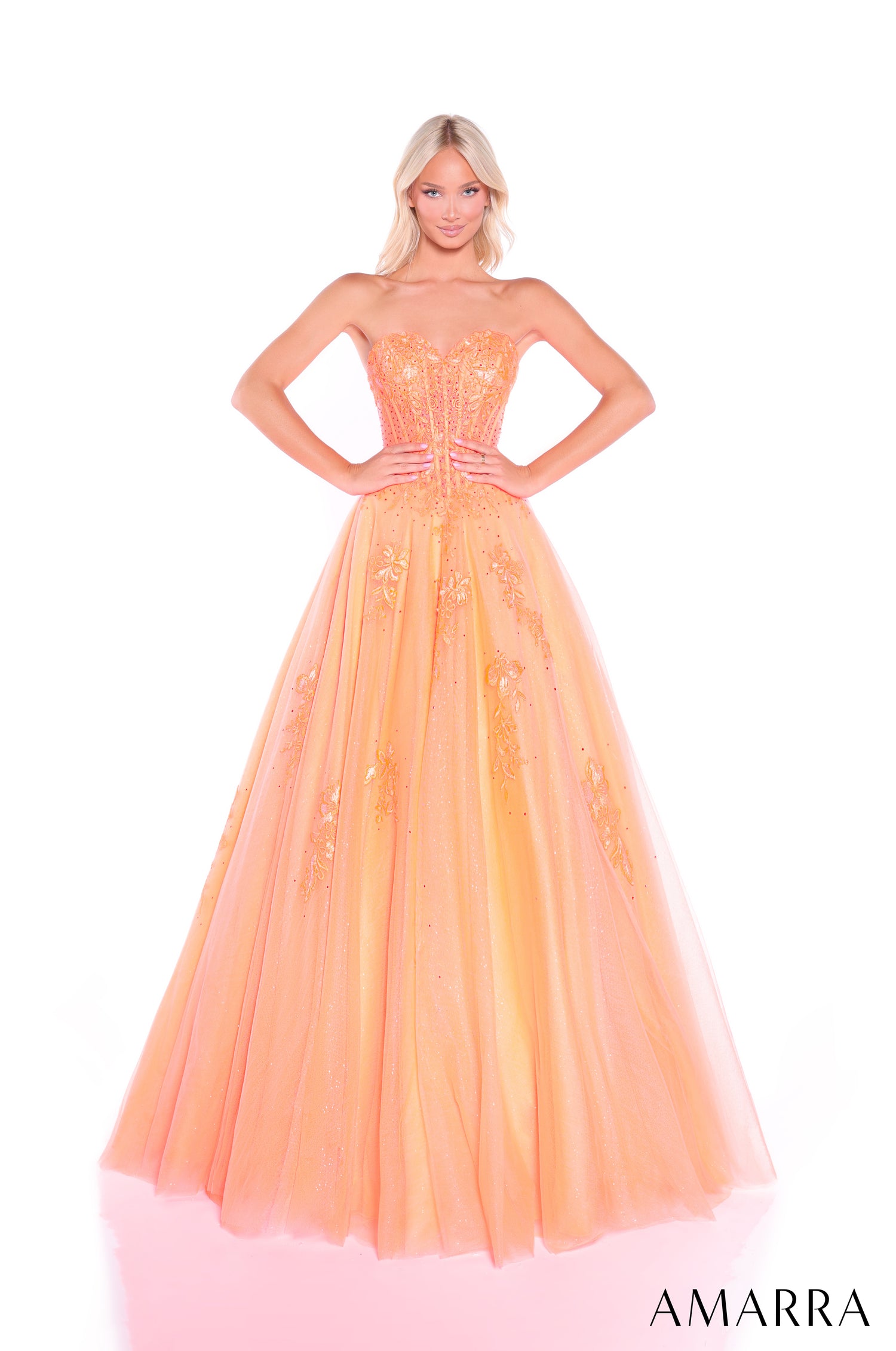 A strapless Orange ballgown with a corset bodice, embellished with sparkly details and a full tulle skirt.