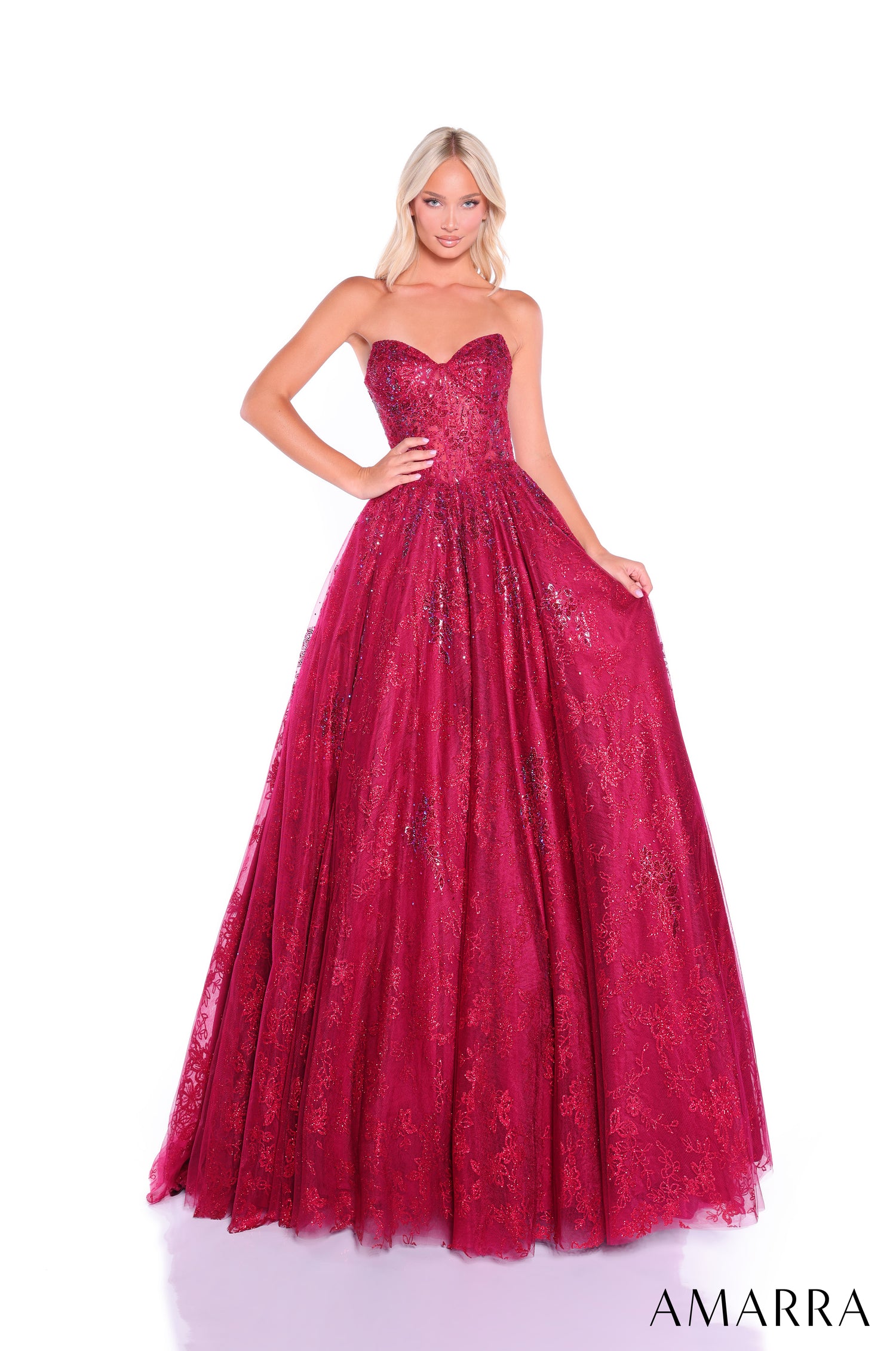 A strapless ball gown in wine-colored glittery lace, with a sweetheart neckline and full, flowing skirt.