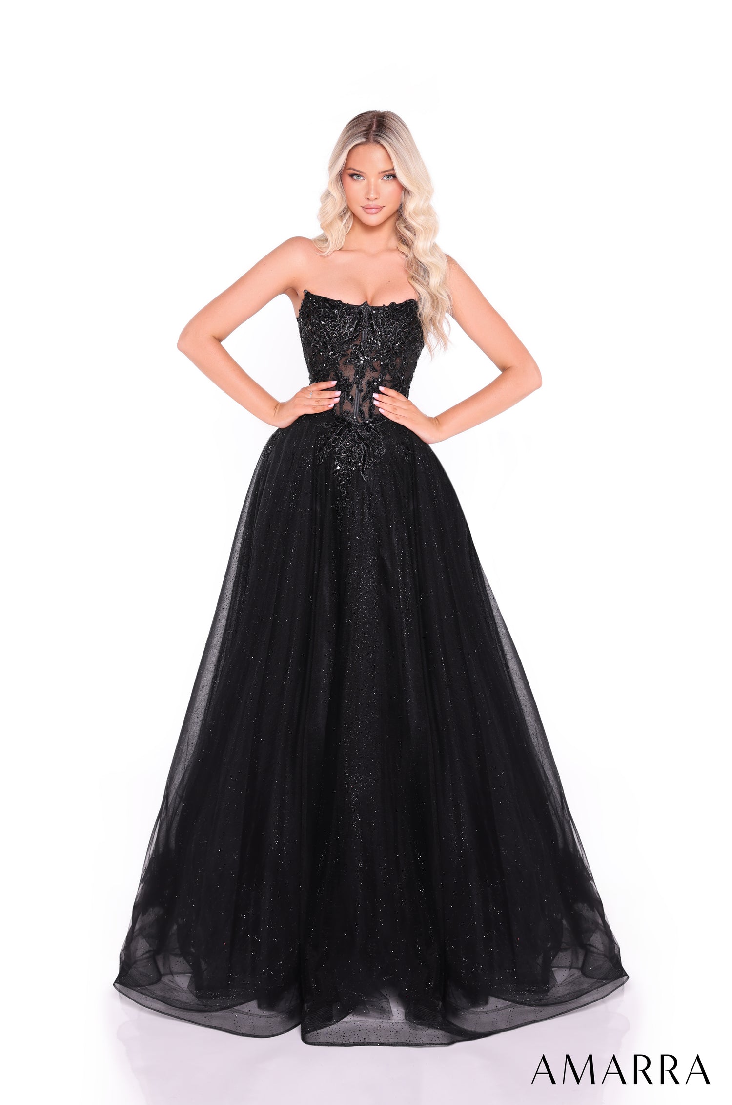A model wears a strapless, floor-length Black ball gown with intricate beaded bodice and full tulle skirt.