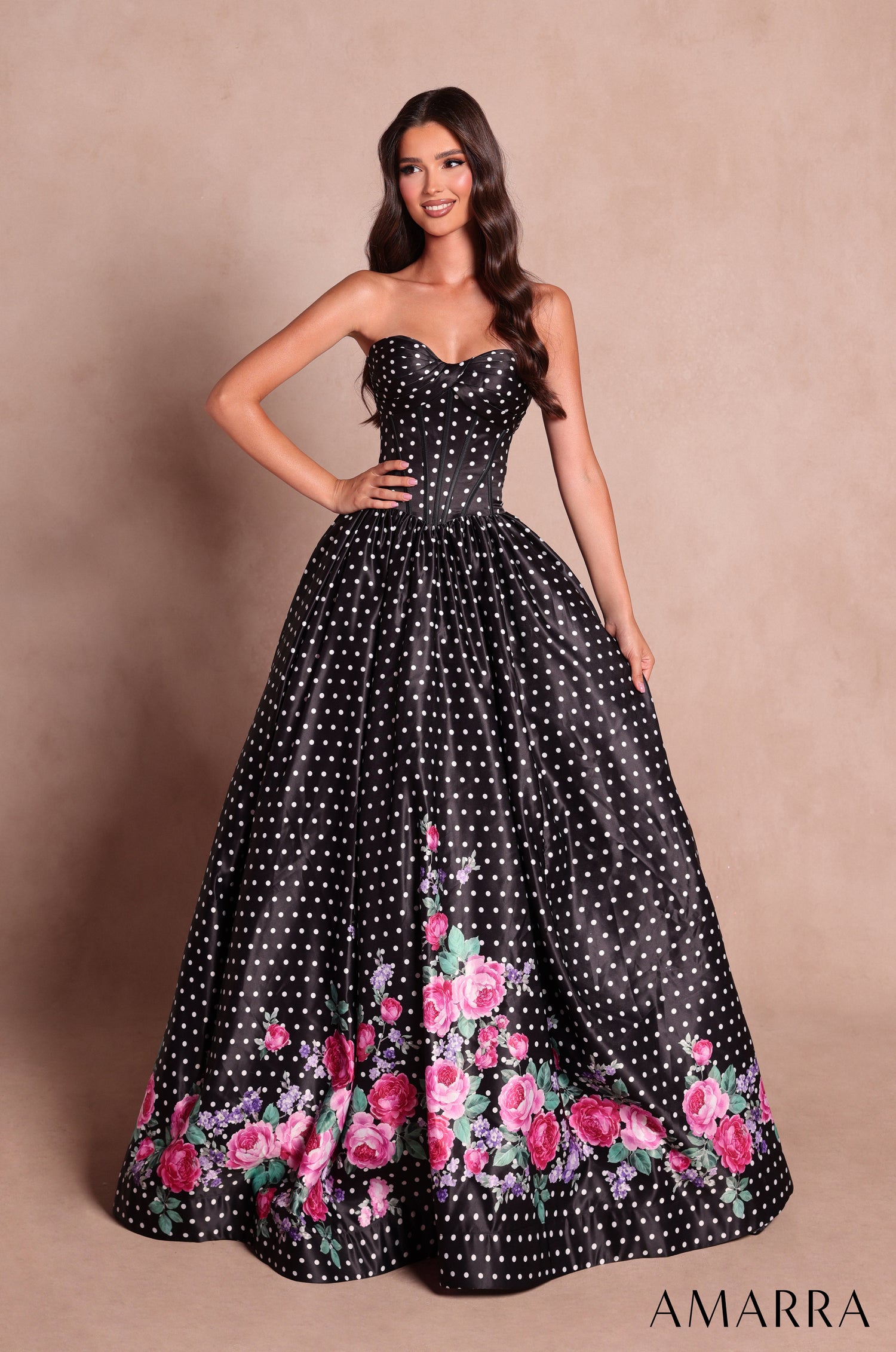Amarra style 89624 long black polka dot dress with white dots, strapless sweetheart corset bodice and pink floral print along the hem of the a-line skirt, front view
