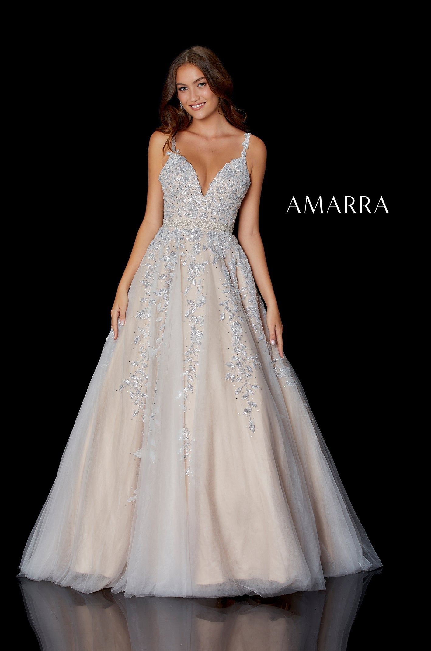 A model wears a champagne/silver ballgown with intricate beaded bodice and full tulle skirt by Amarra.