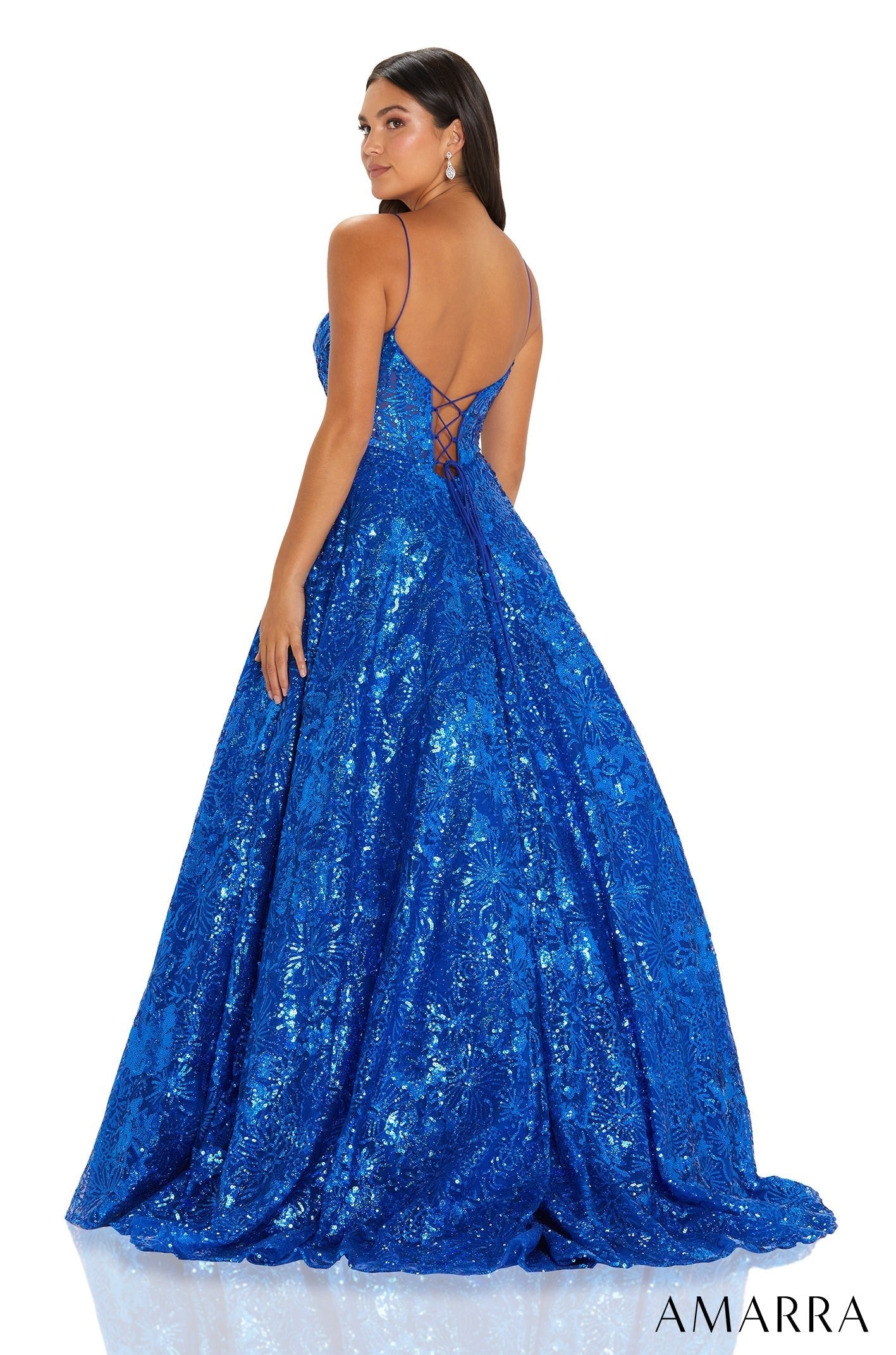 A royal blue sequined ball gown with a sweetheart neckline and corset-style back, photographed from behind.