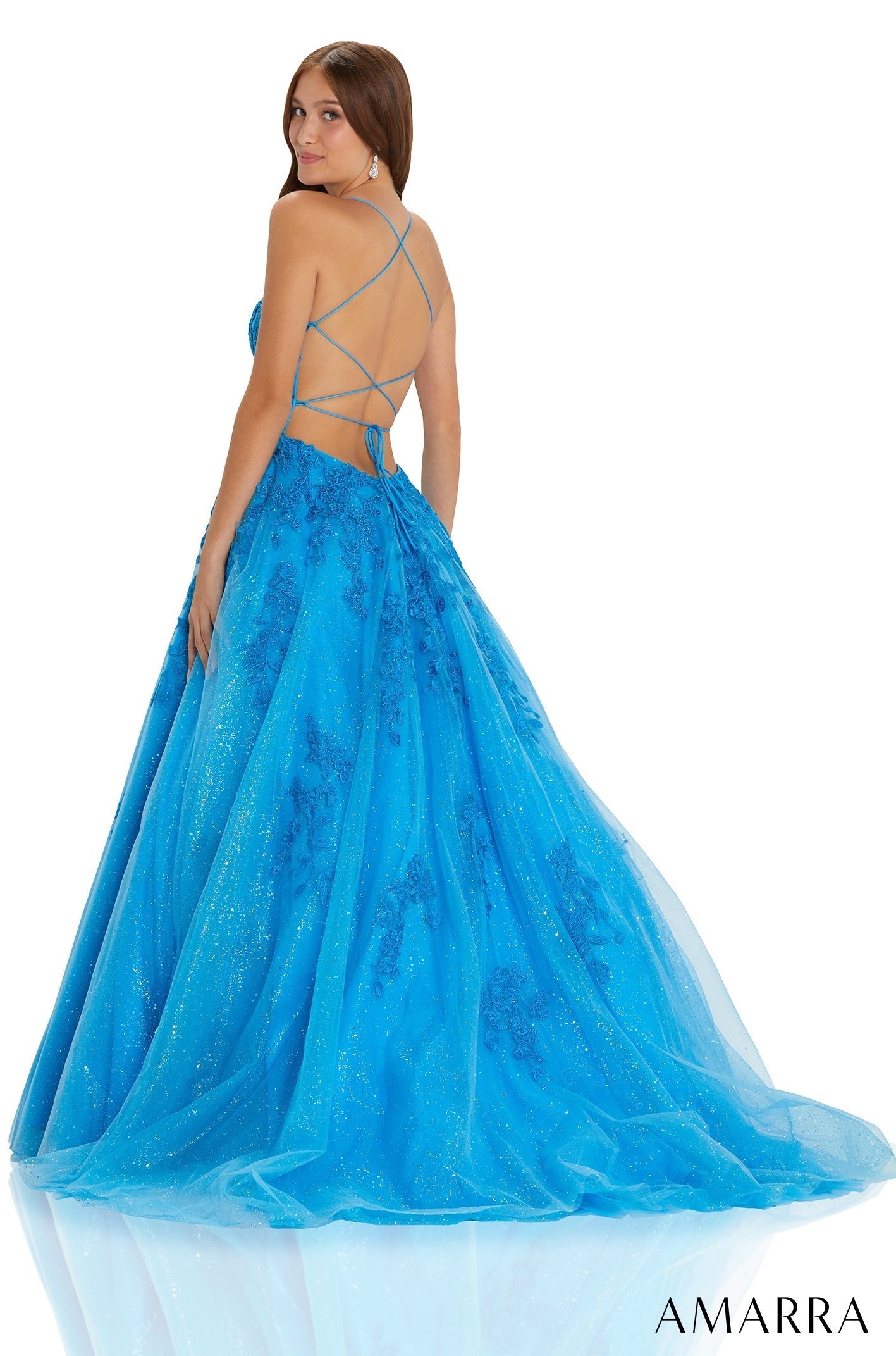 A vibrant blue ball gown with a sparkly tulle skirt and criss-cross back straps.
