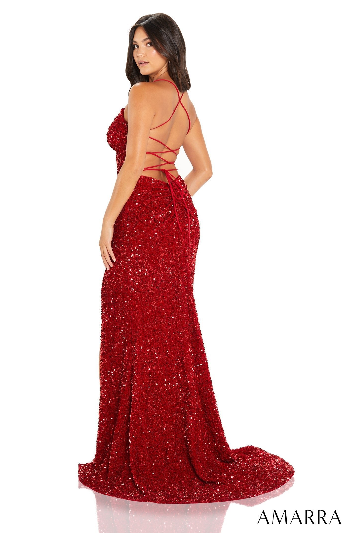 A sparkling red sequin gown with a low back and criss-cross straps, modeled from the back on a white background.