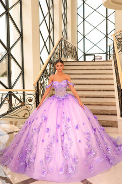 A woman wears a voluminous Lilac/Pink ball gown with 3D floral details, standing on an elegant staircase.
