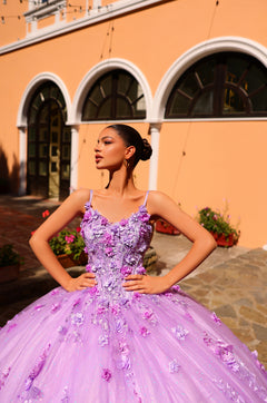 A woman in a lavender ballgown with 3D floral details poses confidently against an orange-walled archway.