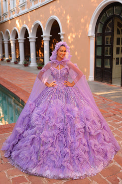 A woman wears a lavish purple ball gown with ruffles and a cape, posing by arched columns.