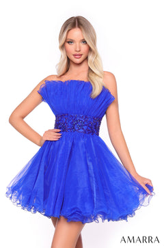 A blonde model wears a strapless, knee-length Bright Royal tulle dress with a beaded waistband.