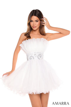 A slim model wears a strapless, ruffled Ivory tulle dress with a jeweled waistband.
