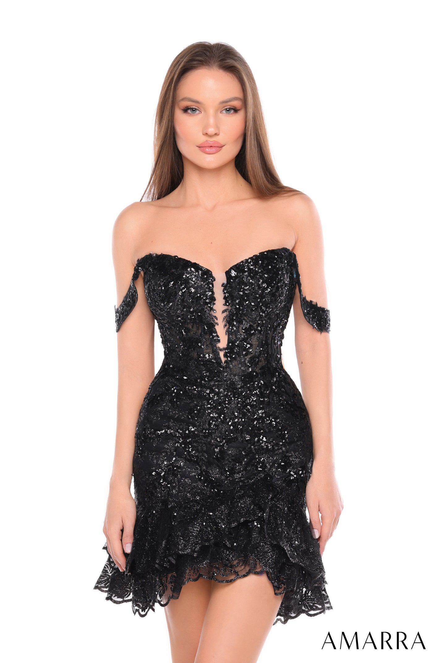 A model wears a strapless, sequined Black cocktail dress with a fitted bodice and ruffled hem by Amarra.