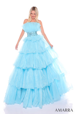 A light blue tiered ball gown with ruffled layers and an embellished waistband on a blonde model.