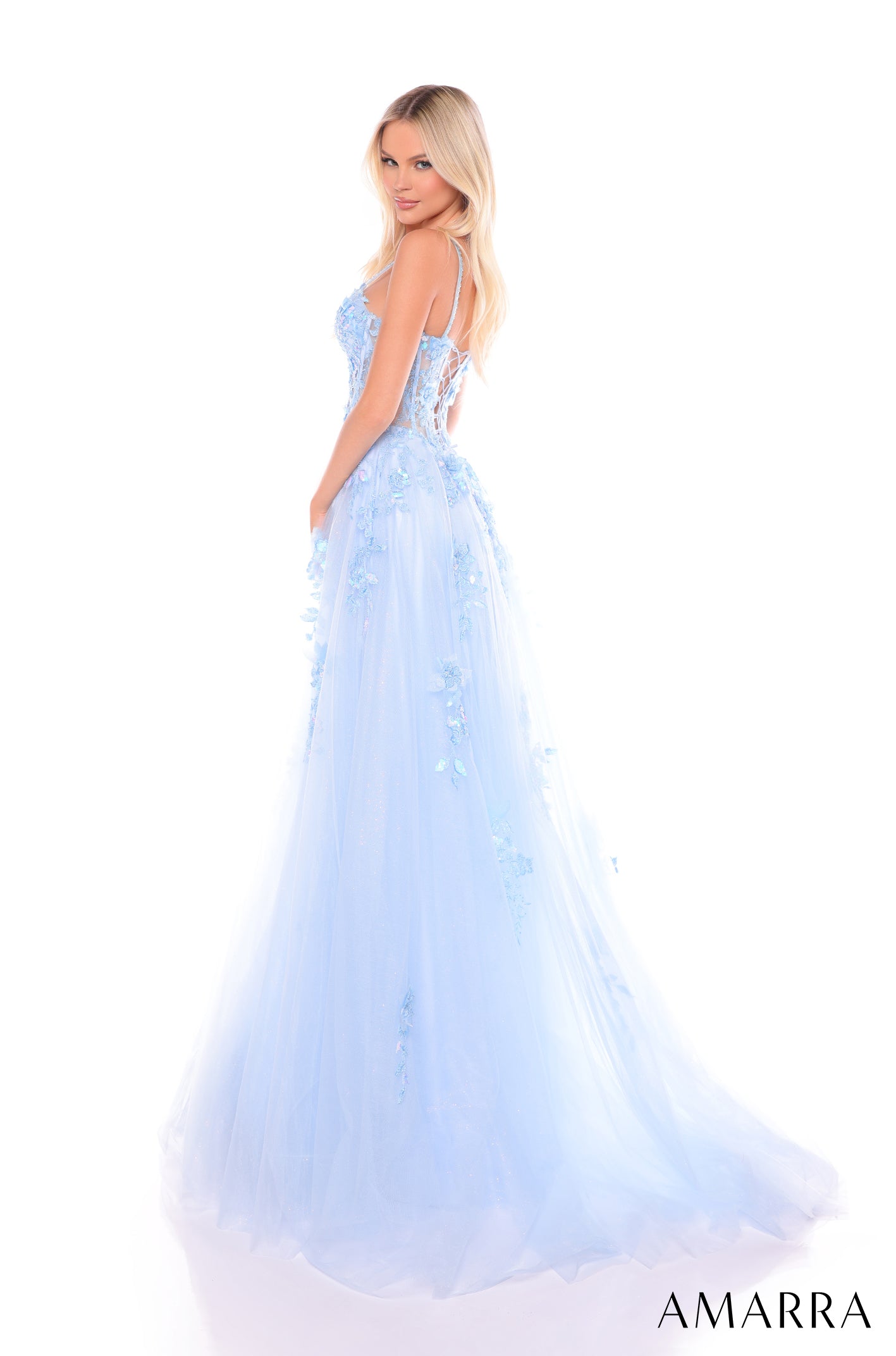 A pale blue, floor-length gown with delicate floral appliqués and a flowing tulle skirt, worn by a blonde model.