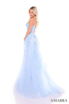 A pale blue, floor-length gown with delicate floral appliqués and a flowing tulle skirt, worn by a blonde model.