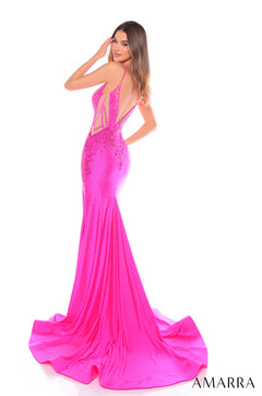 A slender model wears a vibrant pink mermaid-style evening gown with a long, flowing train.