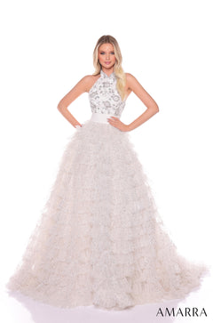 A model wears a sparkling Ivory/Silver halter ball gown with a beaded bodice and full, layered skirt.