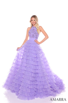 A woman wears a lilac tiered ball gown with an embellished halter top and sparkly ruffled skirt.