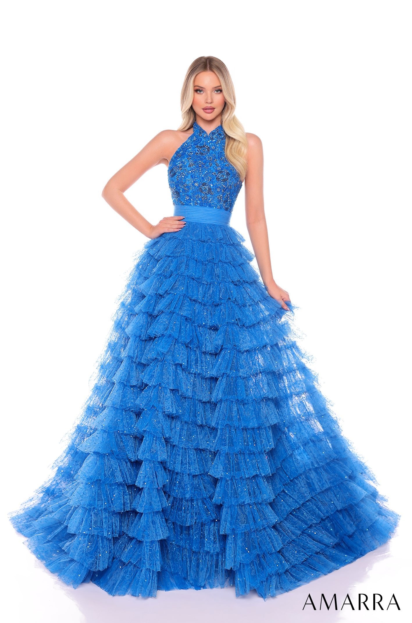 A floor-length peacock blue tiered ball gown with a halter neckline and sparkling embellished bodice.