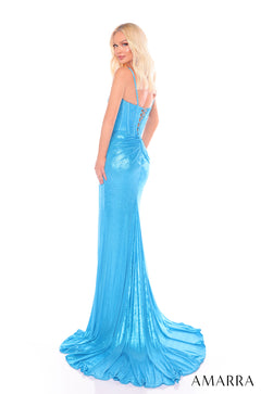 A blonde model wears a shimmering blue corset gown with a long train against a white background.