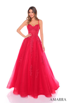 A floor-length red ball gown with lace bodice and full tulle skirt, modeled by a woman in a studio.
