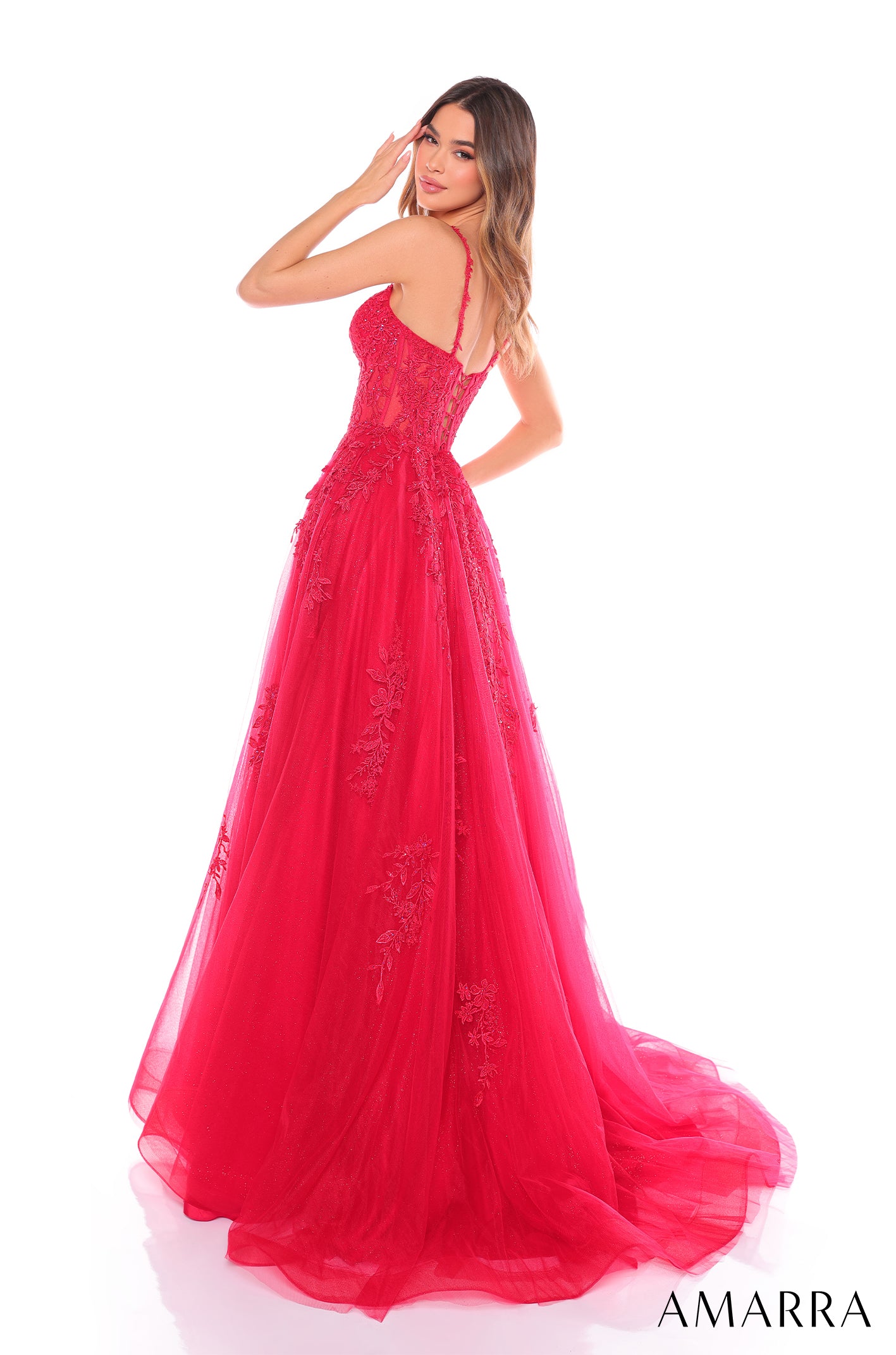 A vibrant red lace ballgown with a fitted bodice and flowing tulle skirt, posed on a white background.