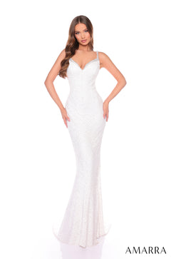 A slender woman wears a shimmering, form-fitting ivory sequin gown with thin straps and a sweetheart neckline.