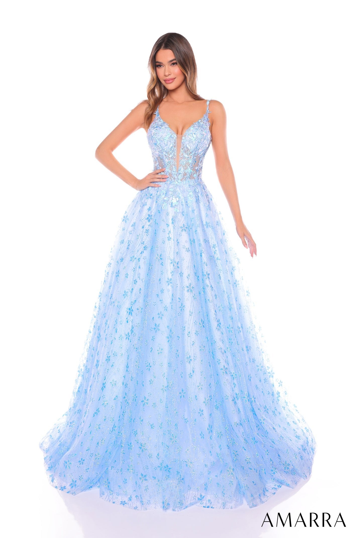 A light blue floral ballgown with a plunging V-neckline and full, flowing skirt on a model with wavy hair.
