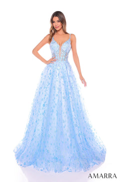 A light blue floral ballgown with a plunging V-neckline and full, flowing skirt on a model with wavy hair.
