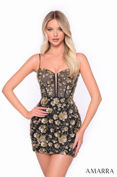 A blonde model wears a fitted Black/Gold floral sequin bustier mini dress by Amarra.