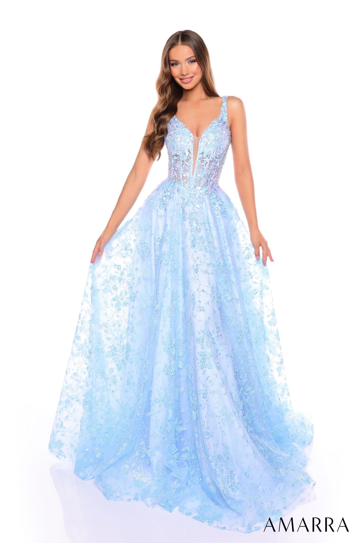 A model wears a light blue sparkly ball gown with a plunging neckline and full tulle skirt by Amarra.