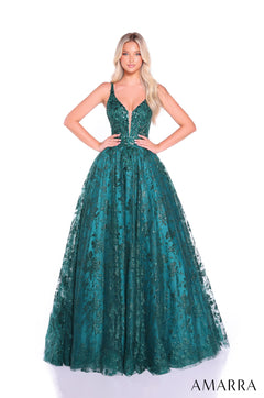 A blonde model wears a full-length emerald green sequined ball gown with a plunging neckline by Amarra.